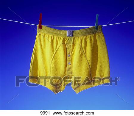 Stock Image - Close-up of man's underwear hanging on clothesline . Fotosearch
