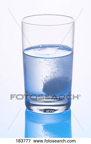 Close-up of pill dissolving in glass of water View Large Photo Image Stock Photo - Close-up of pill dissolving in glass of water . Fotosearch