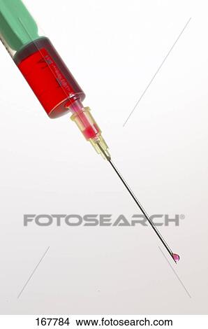Picture - Close-up of syringe with drop of blood on needle tip . Fotosearch