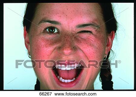 Close-up of teenage girl winking and shouting View Large Photo Image Stock Photo - Close-up of teenage girl winking and shouting . Fotosearch