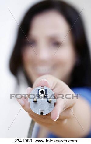 Close-up of woman's hand showing electric plug View Large Photo Image Stock Image - Close-up of woman's hand showing electric plug . Fotosearch