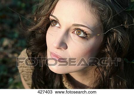 Close-up of young woman looking upward View Large Photo Image Stock Image - Close-up of young woman looking upward . Fotosearch