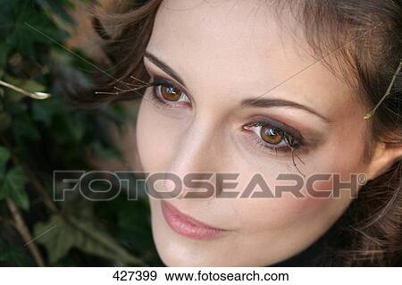Close-up of young woman smiling View Large Photo Image Stock Photo - Close-up of young woman smiling . Fotosearch