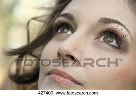 Close-up of young woman thinking View Large Photo Image Stock Image - Close-up of young woman thinking . Fotosearch