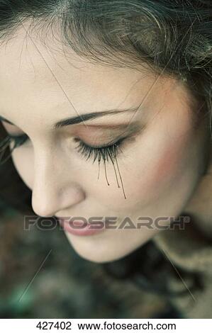 Stock Image - Close-up of young woman with her eyes closed . Fotosearch