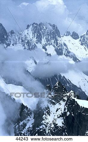 Clouds over snowcapped mountains, Mont Blanc Massif, France View Large Photo Image Stock Image - Clouds over snowcapped mountains, Mont Blanc Massif, France . Fotosearch