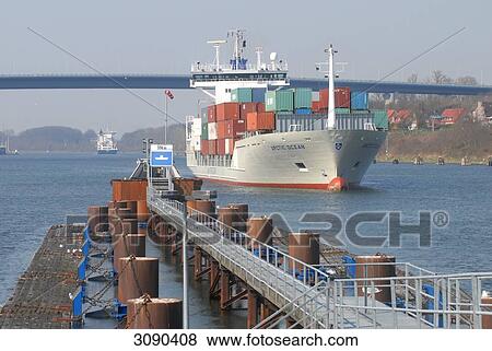 Stock Photo - Container ship on Kiel Canal, Schleswig-Holstein, Germany . Fotosearch