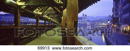 Covered bridge across river at night, Chapel Bridge, Reuss River, Lucerne, Switzerland View Large Photo Image Stock Image - Covered bridge across river at night, Chapel Bridge, Reuss River, Lucerne, Switzerland . Fotosearch