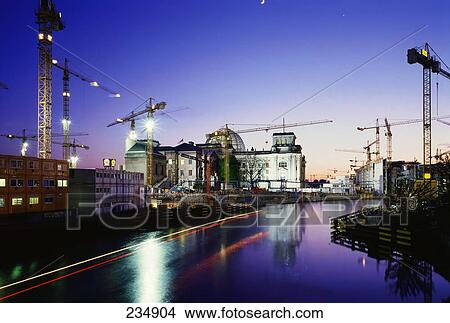 Cranes and building lit up at dusk, Spree River, The Reichstag, Berlin, Germany View Large Photo Image Picture - Cranes and building lit up at dusk, Spree River, The Reichstag, Berlin, Germany . Fotosearch