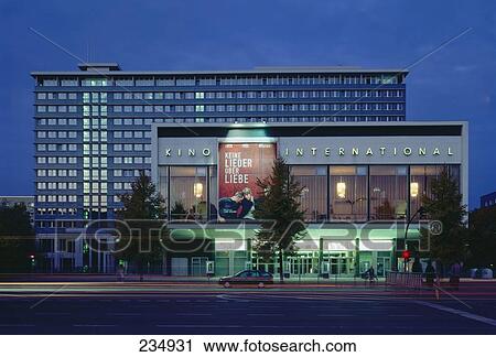 Stock Image - Facade of lit up cinema at dusk, Berlin, Germany . Fotosearch