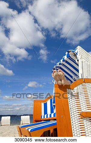 Stock Photography - Feet in beach chair, Gluecksburg, Schleswig-Holstein, Germany . Fotosearch