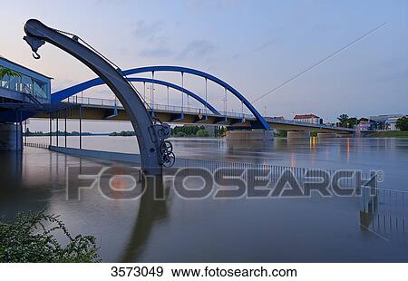 Stock Photo - Flooded Oder with historical crane and bridge between Frankfurt at the Oder, Germany and Slubice, Poland . Fotosearch