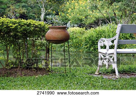 Flower pot and bench in lawn, Thailand View Large Photo Image Stock Image - Flower pot and bench in lawn, Thailand . Fotosearch