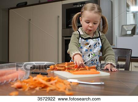 Girl helping peeling carrots View Large Photo Image Stock Image - Girl helping peeling carrots . Fotosearch