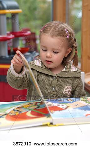 Stock Image - Girl reading a book . Fotosearch