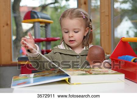 Girl reading a book View Large Photo Image Stock Image - Girl reading a book . Fotosearch