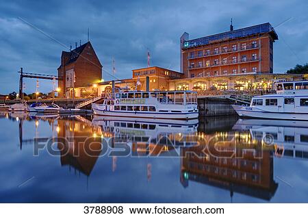 Stock Photo - Granary and hotel at the harbor, Doemitz, Germany . Fotosearch