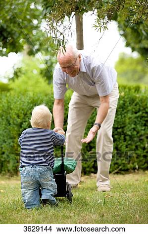 Grandfather and toddler with doll's pram outdoors View Large Photo Image Picture - Grandfather and toddler with doll's pram outdoors . Fotosearch