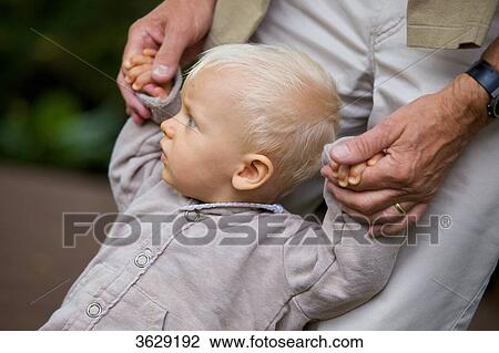 Grandfather helping toddler to walk View Large Photo Image Stock Image - Grandfather helping toddler to walk . Fotosearch