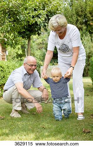 Grandparents with toddler in garden View Large Photo Image Stock Photography - Grandparents with toddler in garden . Fotosearch