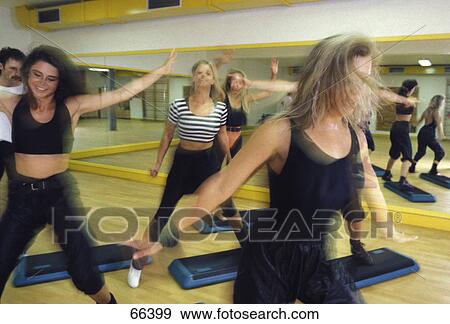 Stock Photo - Group of young women exercising in gym . Fotosearch