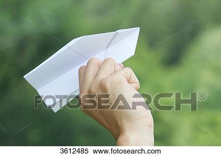 Stock Photography - Hand holding toy airplane, close-up . Fotosearch