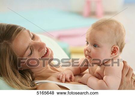 Stock Photo - Happy mother with baby . Fotosearch