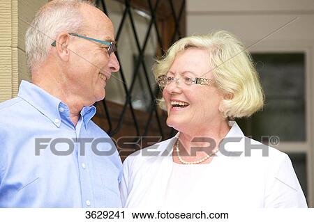 Happy senior couple at the front door View Large Photo Image Stock Image - Happy senior couple at the front door . Fotosearch