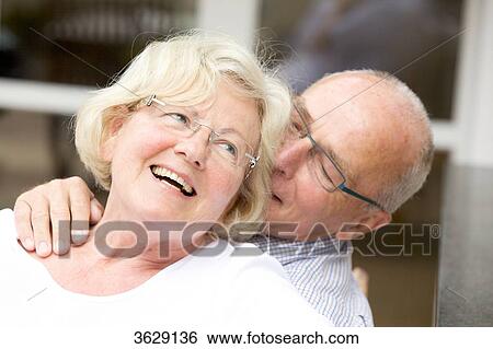 Stock Photograph - Happy senior couple outdoors, portrait . Fotosearch