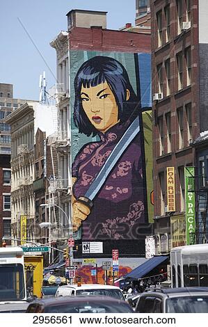 Stock Image - Heavily trafficked Canal Street with painted exterior wall in the background, New York City, USA . Fotosearch