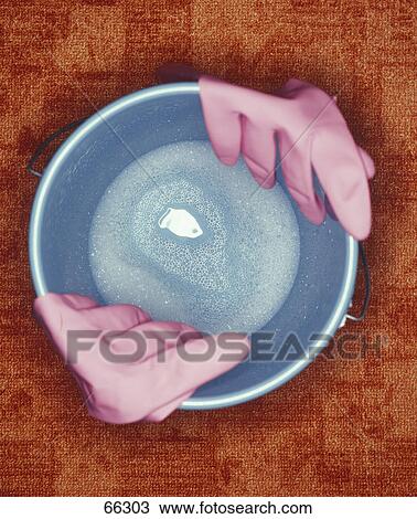 High angle view of gardening gloves at edge of bucket View Large Photo Image Stock Image - High angle view of gardening gloves at edge of bucket . Fotosearch