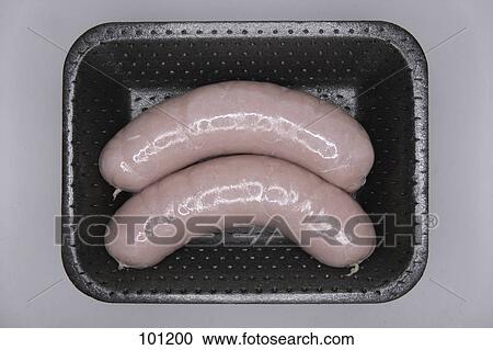 Stock Image - High angle view of sausages in a box . Fotosearch