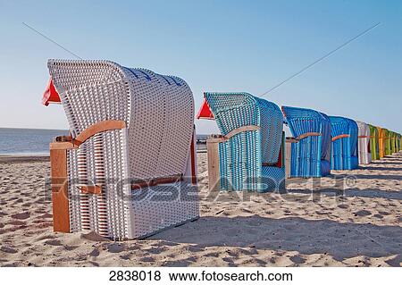 Stock Photo - Hooded beach chairs on beach . Fotosearch