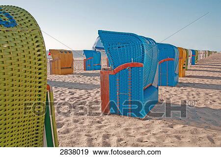 Stock Photo - Hooded beach chairs on beach . Fotosearch