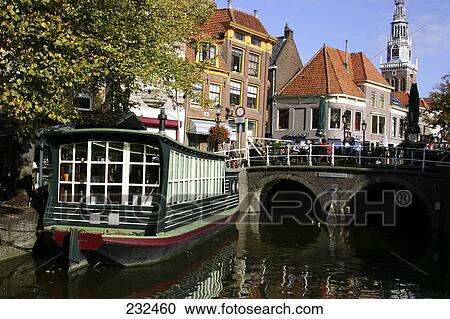 Stock Image - Houseboat near arch bridge, Alkmaar, Netherlands . Fotosearch