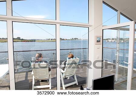 Stock Image - Houseboat on Schlei, Kobberby, Schleswig-Holstein, Germany, Europe . Fotosearch