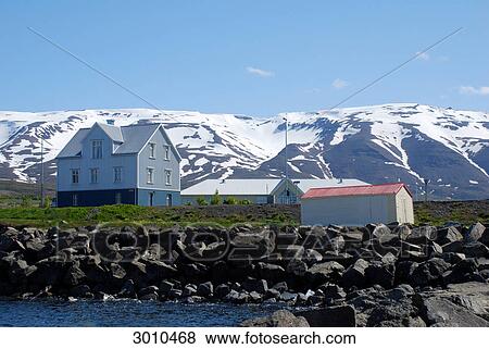 Houses in North Iceland, snow-covered mountains in the background, Grenivik, Iceland, low angle view View Large Photo Image Stock Photo - Houses in North Iceland, snow-covered mountains in the background, Grenivik, Iceland, low angle view . Fotosearch
