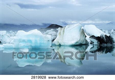 Stock Photo - Ice bergs floating on water . Fotosearch