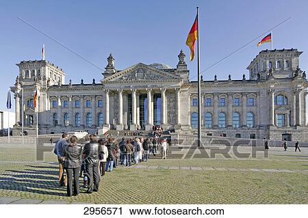 Stock Image - Line of people in front of the Reichstag building, Berlin, Germany . Fotosearch