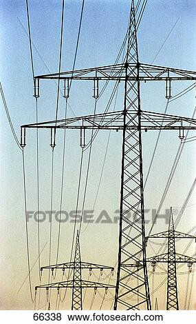 Low angle view of electricity pylons against sky View Large Photo Image Stock Photo - Low angle view of electricity pylons against sky . Fotosearch