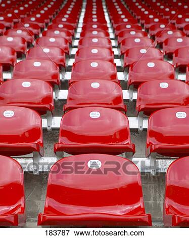Low angle view of empty chairs at football stadium View Large Photo Image Stock Photo - Low angle view of empty chairs at football stadium . Fotosearch