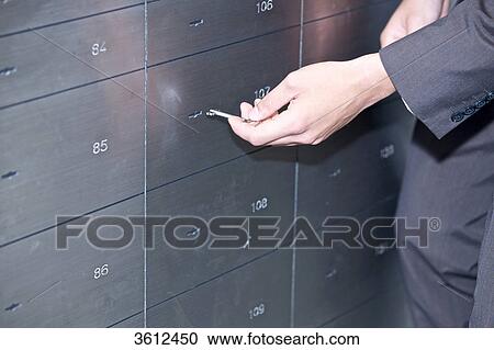 Man opening safe deposit box, close-up View Large Photo Image Stock Image - Man opening safe deposit box, close-up . Fotosearch