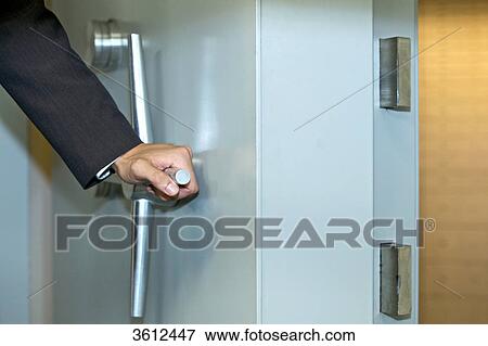 Stock Photo - Man opening vault, close-up . Fotosearch