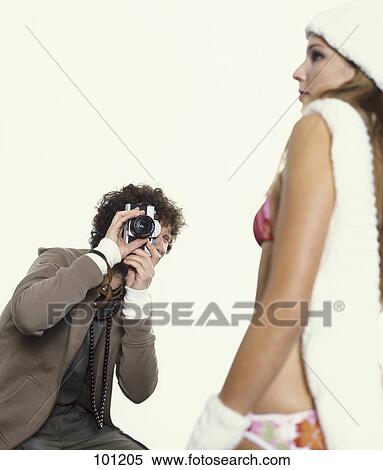Stock Photography - Man taking picture of woman . Fotosearch