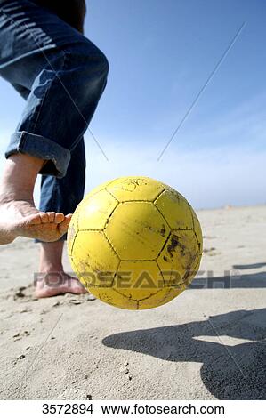 Picture - Man with football at beach, Schleswig-Holstein, Germany, Europe . Fotosearch