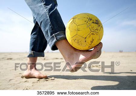 Man with football at beach, Schleswig-Holstein, Germany, Europe View Large Photo Image Stock Photography - Man with football at beach, Schleswig-Holstein, Germany, Europe . Fotosearch