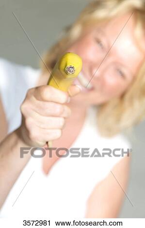 Mature woman pointing with banana View Large Photo Image Stock Image - Mature woman pointing with banana . Fotosearch