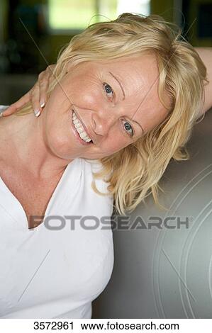 Mature woman touching her shoulder View Large Photo Image Stock Image - Mature woman touching her shoulder . Fotosearch