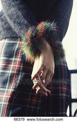 Mid section view of young woman crossing her hands behind her back View Large Photo Image Stock Photo - Mid section view of young woman crossing her hands behind her back . Fotosearch