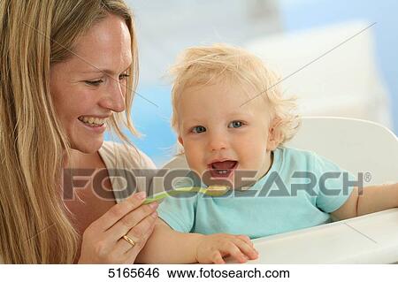 Mother feeding baby View Large Photo Image Stock Photograph - Mother feeding baby . Fotosearch